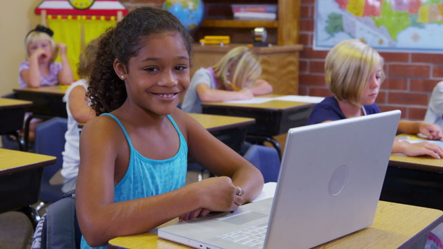 Portrait of elementary school student with laptop computer