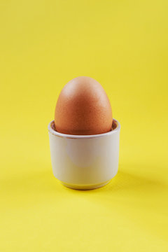 Boiled egg on a vibrant yellow background 