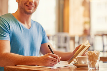 Cheerful man making notes