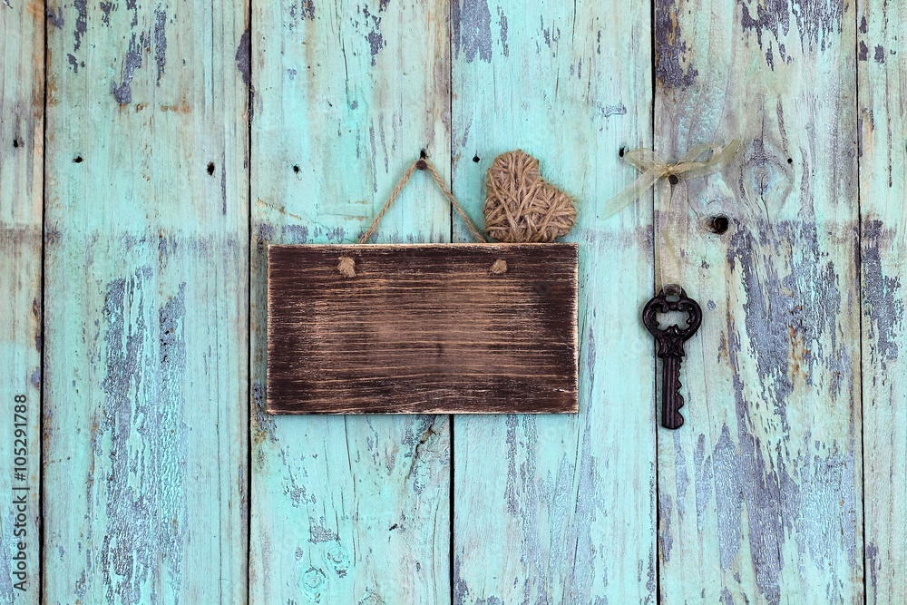 Wall mural blank rustic sign with heart and antique key hanging on teal blue wood background