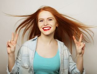 lovely woman showing victory or peace sign