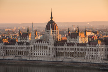 Fototapeta na wymiar Illuminated Hungarian Parliament Building in Budapest, Hungary at Sunrise