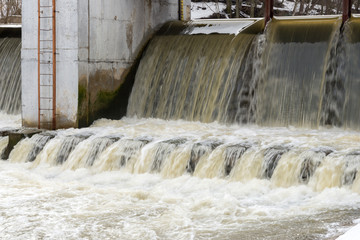 Spring flood on the river dam. High water