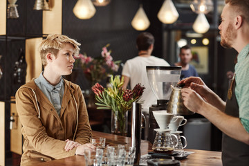 Woman having a coffee tasting session at modern cafe
