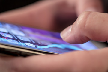 Detail of woman fingers and touch screen of smartphone