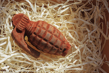 Chocolate grenade in a box on straw