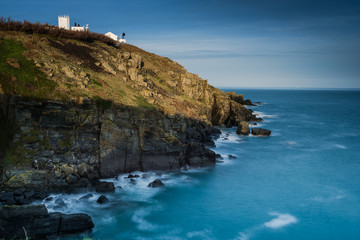 Fototapeta na wymiar Trinity Lighthouse on rocky coast in Cornwall, UK.