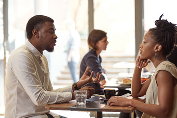 African entrepreneur explaining his idea to a businesswoman in c