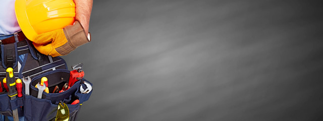 Builder handyman with construction tools.