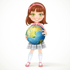 Cute little girl in school uniform holding a globe in his hands.