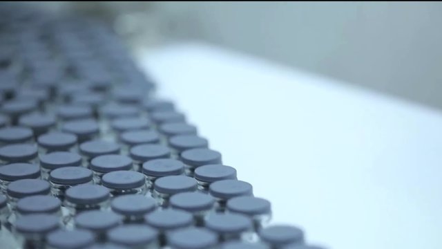 Detail of automated line for marshalling bottles of medicines.
