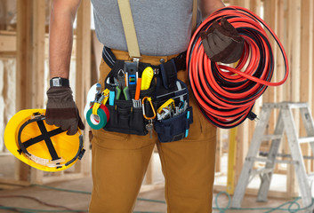 Fototapeta na wymiar Electrician with construction tools and cable.