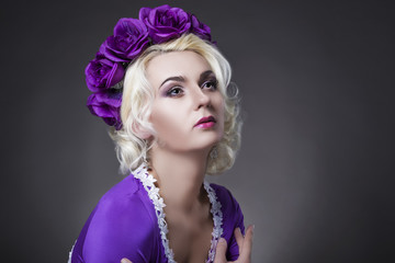 Fototapeta premium Fashion and Beauty Concepts. Portrait of Blond Caucasian Female With Violet Crown Against Black