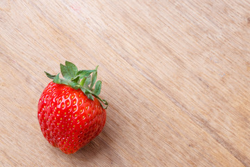 Red fresh strawberry fruit on wooden table.