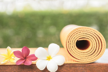 yoga mat on table with flower