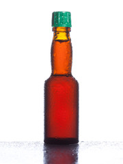 Balsamic brown bottle with liquid drops