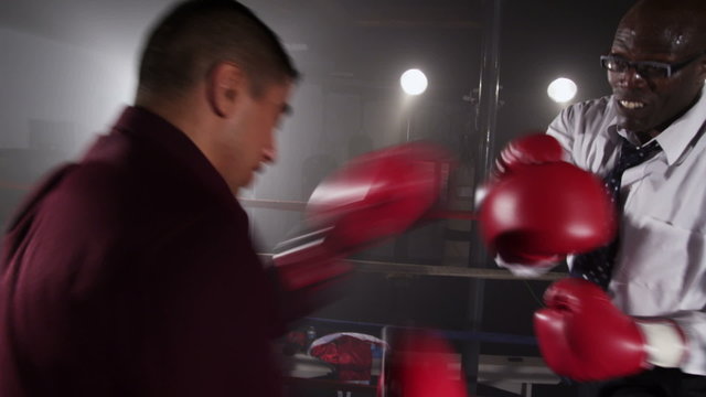 Businessmen boxing in ring