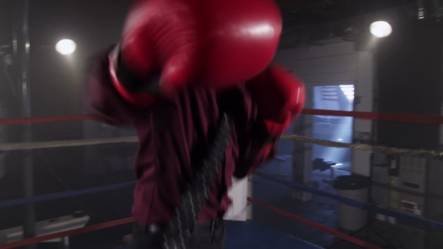 Businessman boxing in ring