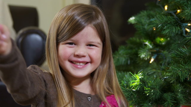 Young girl holding Christmas ornament