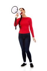 Young angry woman screaming through a megaphone