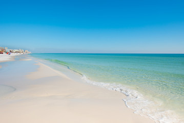 Fototapeta na wymiar sunny day white sand beach with blue sky and blue green water
