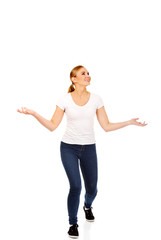 Young woman trying to catch something falling from the sky