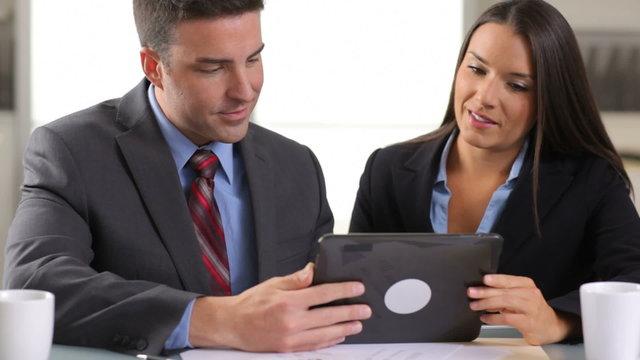 Business man and woman using digital tablet in office