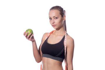 attractive fitness model with measuring tape on a white background