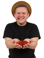 Young fat man with chili in his hands.