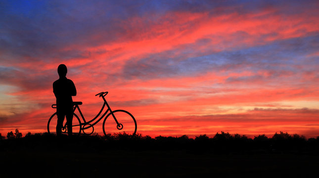 Cyclists at sunset background.