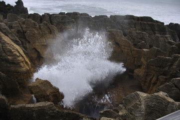 The main blowhole at Punakaiki on the West Coast of New Zealand, named Pluto, erupts with a gush of seawater at high tide.