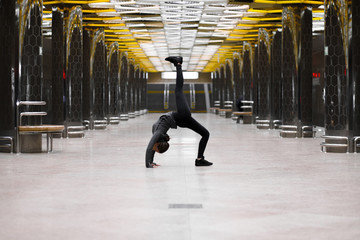 Young woman working out in an urban setting, a series yoga poses