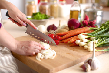 Young Woman Cooking in the kitchen. Healthy Food