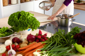 Young Woman Cooking in the kitchen. Healthy Food