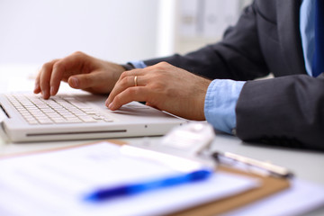 Obraz na płótnie Canvas businessman working at a computer hands closeup