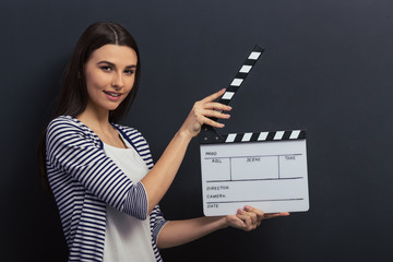 Handsome girl with clapperboard