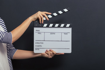 Fototapeta premium Handsome girl with clapperboard
