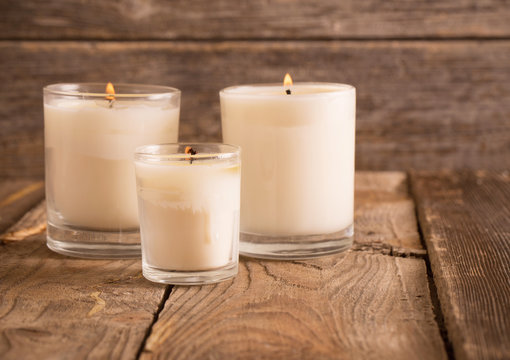 scented candles on old wooden background