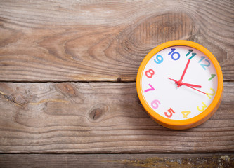 modern alarm clock with colorful number on wooden background