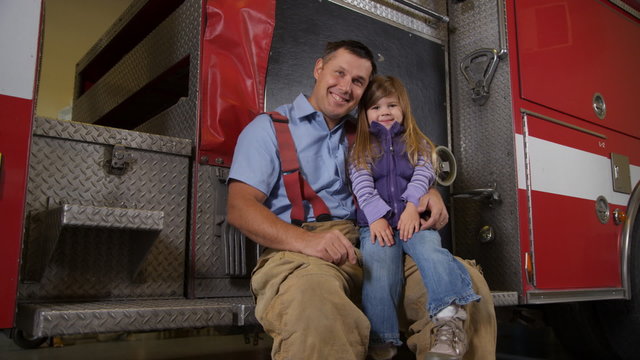 Portrait of firefighter and young girl