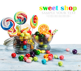 Fototapeta na wymiar multicolored lollipops, candy and chewing gum in glass jar