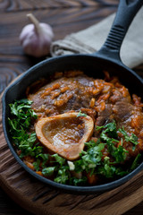 Close-up of a frying pan with ossobuco, selective focus