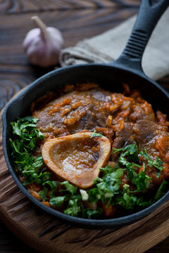 Close-up of a frying pan with ossobuco, selective focus