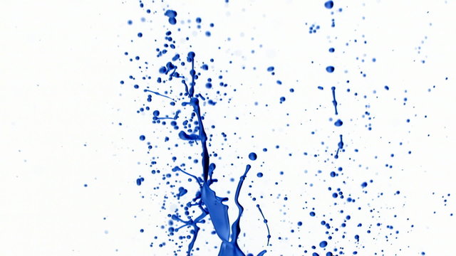 Blue paint splattering on white background, slow motion