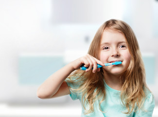 Child girl brush teeth.