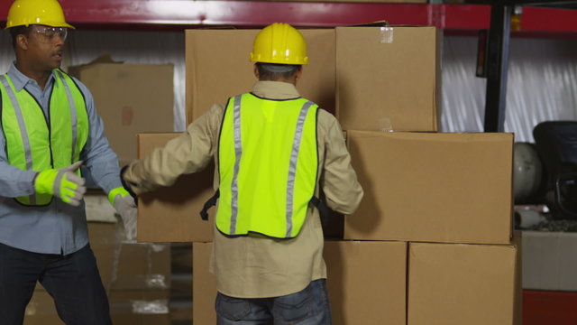 Workers stacking boxes