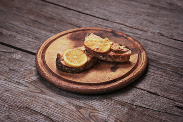 Fried salmon fillet on plate with lemon.