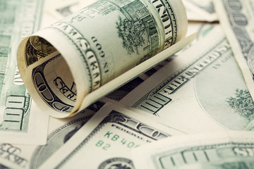 Heap of cash US dollar bills background, closeup
