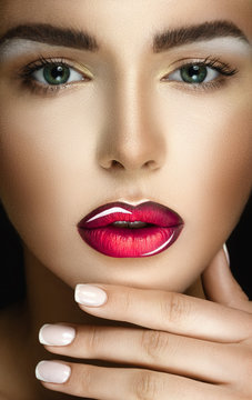 Beautiful young model with bright make-up and manicure
