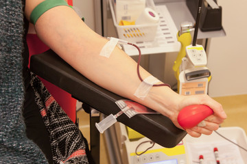 Donor in an armchair donates blood